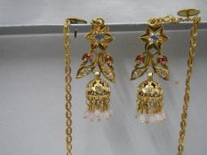 A pair of 22ct gold diamond and ruby earring with chains, 12 grams including stones.