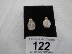 A pair of yellow gold oval earring sets diamonds, weight 2.g grams.