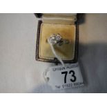 A 14 ct white gold and diamond cross over ring, size M.