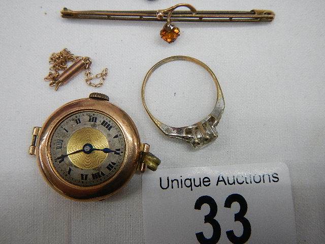 A 9ct gold ring size R Half, A gold ladies watch head, a small chain a/f and two brooches. - Image 4 of 5