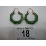 A good pair of jade earrings with possibly gold mounts.