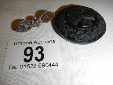 A Victorian Irish bog oak mourning brooch together with a Scottish sterling silver bar brooch.