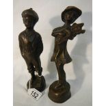 A pair of 20th century bronze figures of a boy and girl, 23 cm tall.