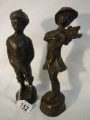 A pair of 20th century bronze figures of a boy and girl, 23 cm tall.