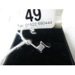 An 18ct white gold 4 stone diamond ring, good clarity, size M.