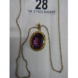 A 14 ct rolled gold pendant set amethyst coloured stone.
