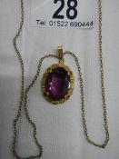 A 14 ct rolled gold pendant set amethyst coloured stone.