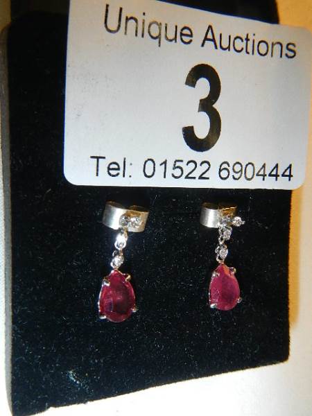 A pair of 14ct white gold earrings set with pear shaped rubies. - Image 4 of 5