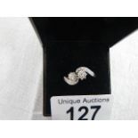 An 18ct white gold crossover diamond ring of 80pts, weight 4.4 grams, size N.