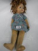 An early 20th century Chad Valley 'Bambina' doll with glass eyes and original button on right side