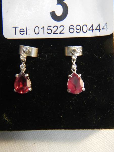 A pair of 14ct white gold earrings set with pear shaped rubies. - Image 3 of 5