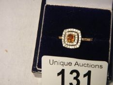 A rare 75 point yellow diamond 18ct gold ring surrounded by 45 point brilliant white diamonds,