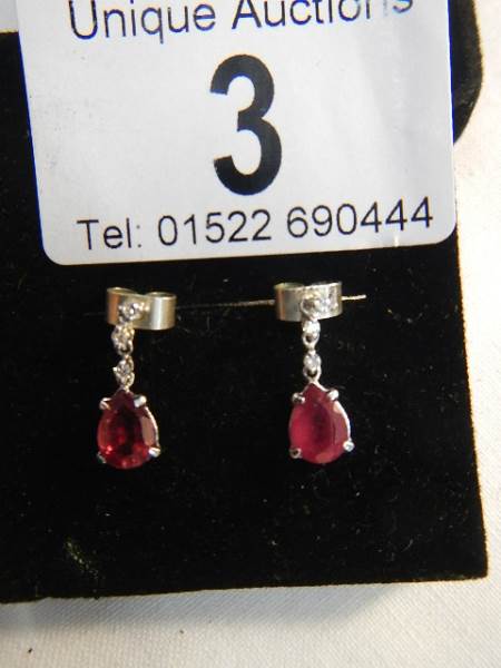 A pair of 14ct white gold earrings set with pear shaped rubies. - Image 5 of 5