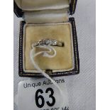 An 18ct gold and platinum ring set 3 small diamonds, size L.