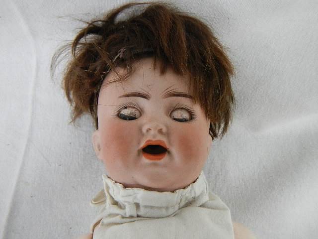 A small early 20th century German bisque headed doll by Kammer and Reinhardt with moveable arms, - Image 2 of 5