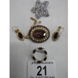 Three good quality brooches and a pair of earrings set with assorted coloured stones.