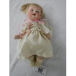 An early 20th century bisque headed doll, 19.5 cm.