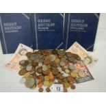 A mixed lot of coins, 2 old £10 notes and 3 empty coin booklets.