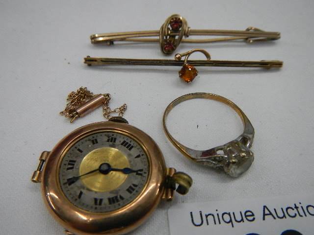 A 9ct gold ring size R Half, A gold ladies watch head, a small chain a/f and two brooches. - Image 2 of 5