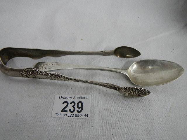 A silver spoon and silver sugar nips. ****Condition report**** Weight approx.