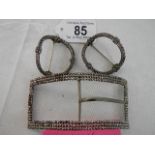 A pair of vintage shoe buckles and a larger buckle.