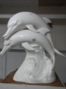 A large white ceramic dolphin group 49 cm tall a/f base has a number of hairline cracks.