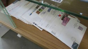 A quantity of first day covers and an album of stamps.