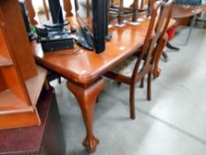 A Victorian mahogany wind out dining table with ball and claw feet with 1 leaf