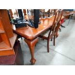 A Victorian mahogany wind out dining table with ball and claw feet with 1 leaf