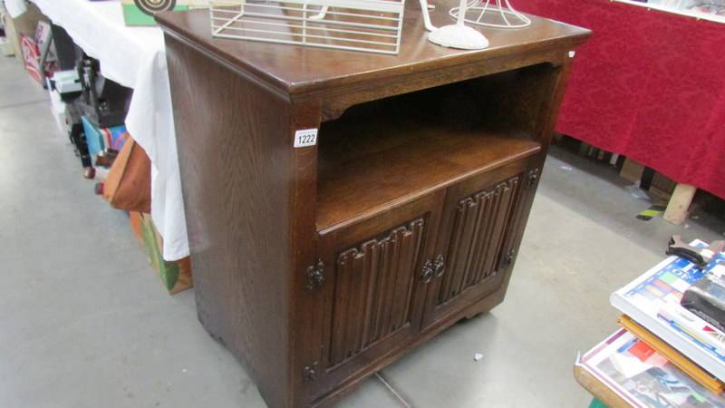 An oak cabinet with linen fold doors.