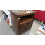 An oak cabinet with linen fold doors.