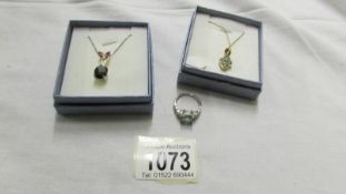 A silver gilt pendant, a silver pendant and a silver ring.