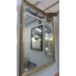A large gilt framed bevel edged mirror.