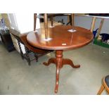 A dark pine round kitchen table on centre column tripod base height 76cm,