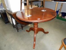 A dark pine round kitchen table on centre column tripod base height 76cm,