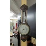 An oak barometer/thermometer.
