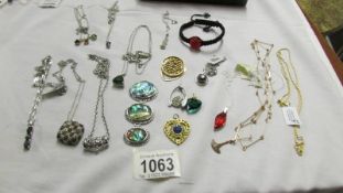 A mixed lot of pendants, chains etc.