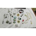 A mixed lot of pendants, chains etc.