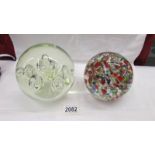 A large heavy opaque glass paperweight together with a large heavy multicoloured glass paperweight,
