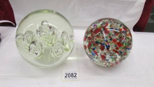 A large heavy opaque glass paperweight together with a large heavy multicoloured glass paperweight,