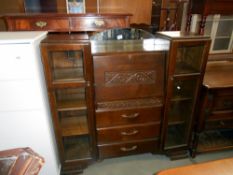 A 1930's oak bureau with side bookcases with art deco cut glass panels, height 122cm,