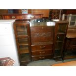 A 1930's oak bureau with side bookcases with art deco cut glass panels, height 122cm,