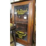 A sign written mahogany inlaid cabinet.
