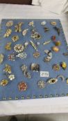 Approximately 40 vintage and mid 20th century brooches in various designs including a mermaid.