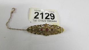 An antique diamond and ruby brooch in 15ct gold, total weight 5.4 grams.