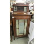 A mahogany cabinet with bevelled glass lettered door 'Cage Bros. Chicago'.