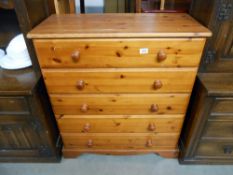 A modern solid pine 5 drawer bedroom chest, Height 94cm, width 87cm approx.