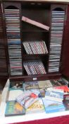 A large quantity of music CD's including Alfie Bo, Kathryn Jenkins, Kiri together with CD cabinet,