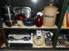 2 shelves of kitchen ware including stoneware bread bin, set of saucepans, etc.