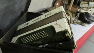 A cased Carmen piano accordion.